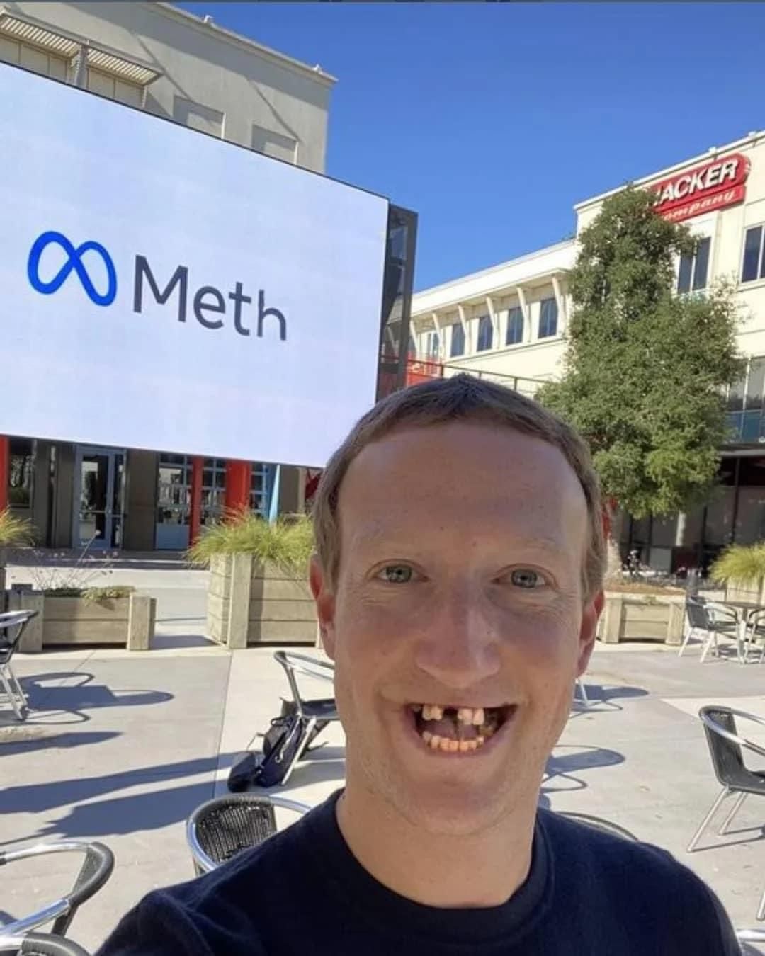 Man in front of a sign reading Meth, a play on the Meta logo